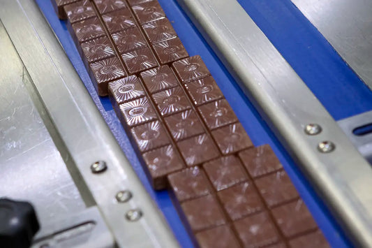 wheybetter chocolate on a conveyor belt